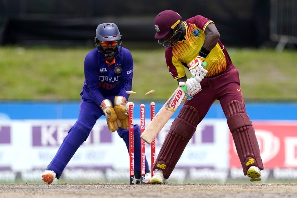 West Indies' Devon Thomas, right, is bowled by India's Axar Patel during the fifth and final T20 cricket match, on Sunday, in Lauderhill, Florida. At left is India wicketkeeper Dinesh Karthik. (AP Photo)