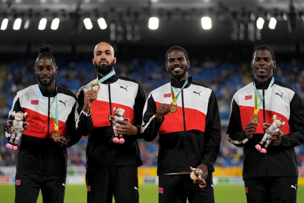 SUPERB RUN: Team TT poses on the podium after winning the gold medal in the Men's 4 x 400 meters relay during the athletics competition in the Alexander Stadium at the Commonwealth Games in Birmingham, England, on Sunday. - Alastair Grant