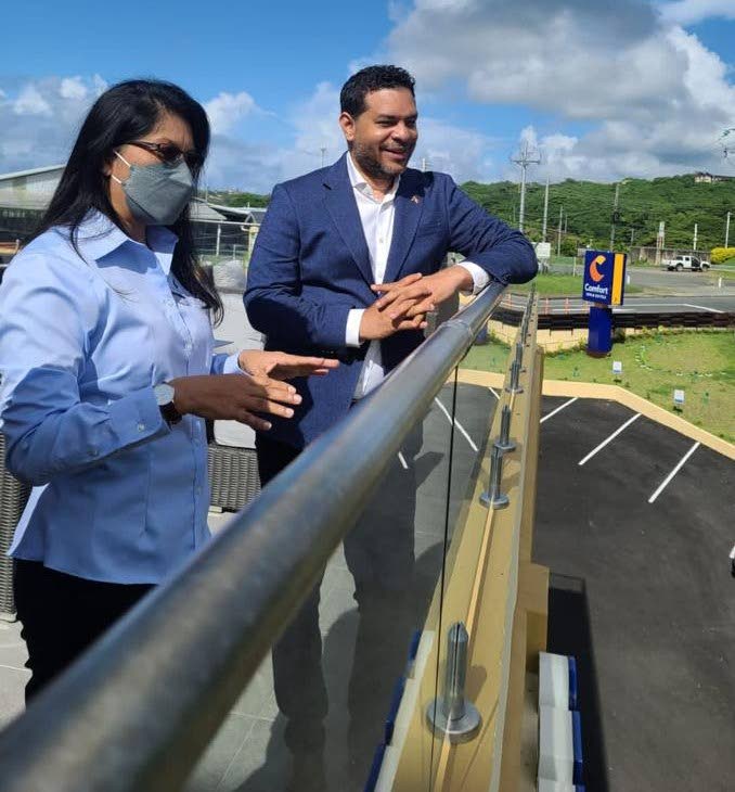Minister of Tourism Randall Mitchell, right, enjoys the views on a tour of Comfort Inn & Suites with general manager Maria Yip-John on Monday morning.  - 