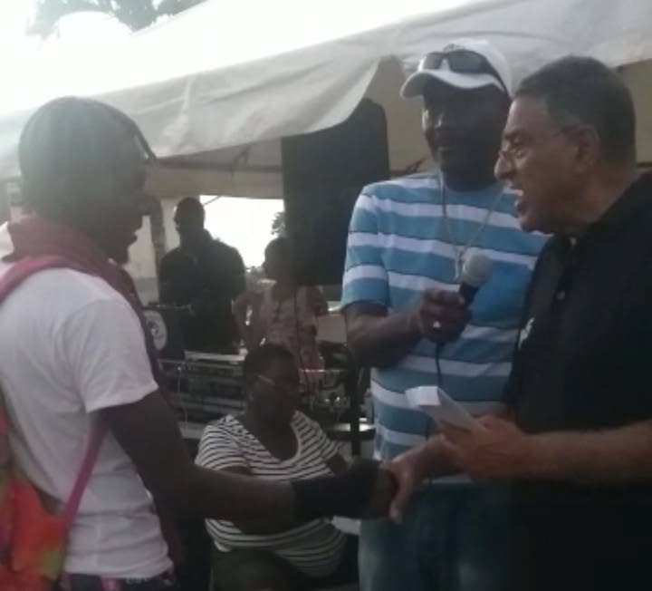 Councillor Terry Rondon, right, presents a prize to a member of the Balandra Cricket Club. - 
