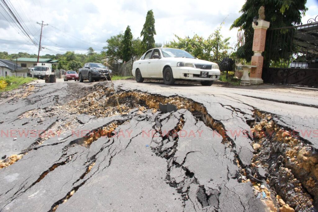 Single lane traffic along Papourie Road, upper Barrackpore after a major landlsip  eroded the main road on August 10. - FILE PHOTO/LINCOLN HOLDER