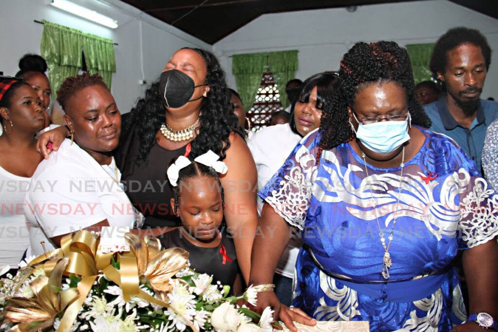 Keishallene Lewis-Morrison (in black), Otis Morrison's widow, breaks down in tears Thursday upon viewing the body of the 36-year-old father who drowned after saving Tahira Checkley, 11, at Clifton Hill beach, Point Fortin. - Marvin Hamilton