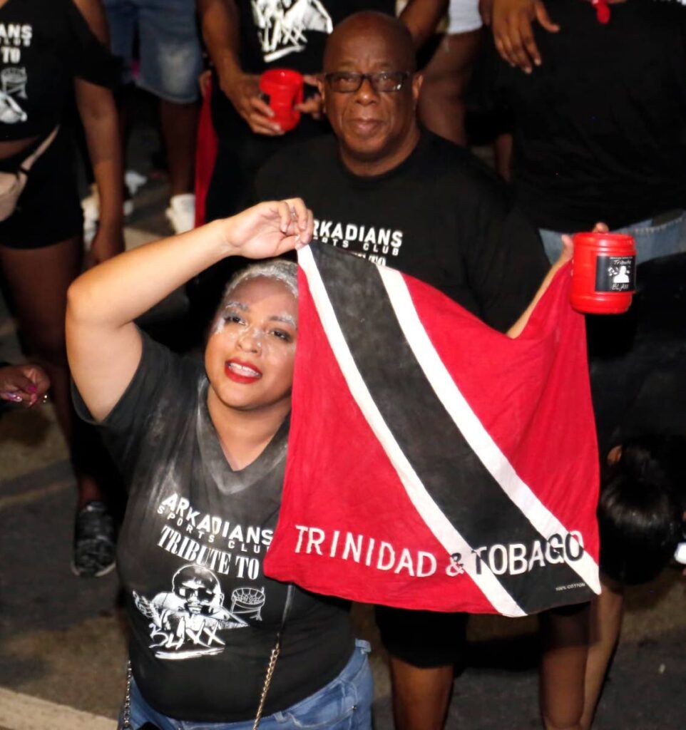 This reveller at the Arima Borough Day celebrations shows her colours at the Independence Road Show in Arima.

  - 