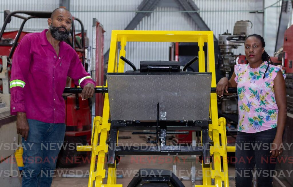 Deon Rojas, managing director of Rojas Engineering Ltd, and his wife Josanne, administrative manager, stand next to the leg press they built for a customer at Rojas Engineering Ltd, Cove, Canoe Bay, Tobago.
 - David Reid