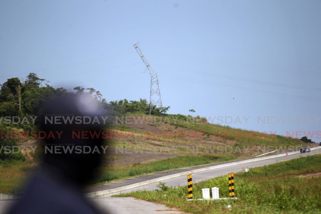 The damaged TTEC electrical tower along the Solomon Hochoy Highways near Grant Trace Rousillac which was responsible for a power outage that affected 30% of the country due to a landslip on Tuesday night. - Photo by Lincoln Holder