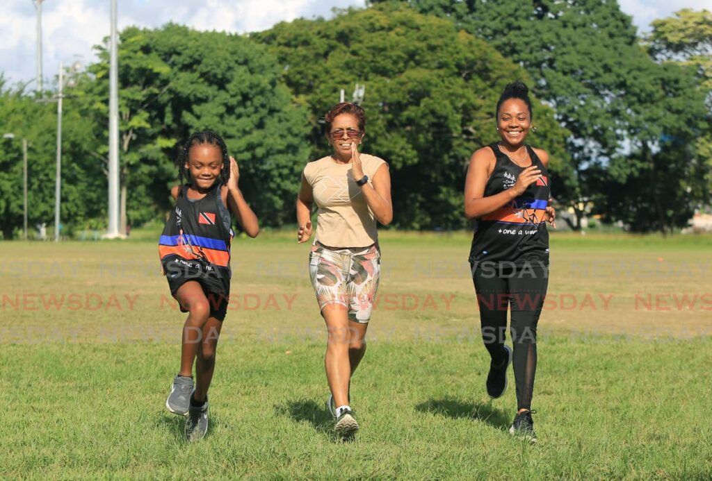  Arya Joseph runs with her grandmother Sheriffa Ward and mother Alkansa Ward-Joseph at Eddie Hart Grounds, Tacarigua. - SUREASH CHOLAI