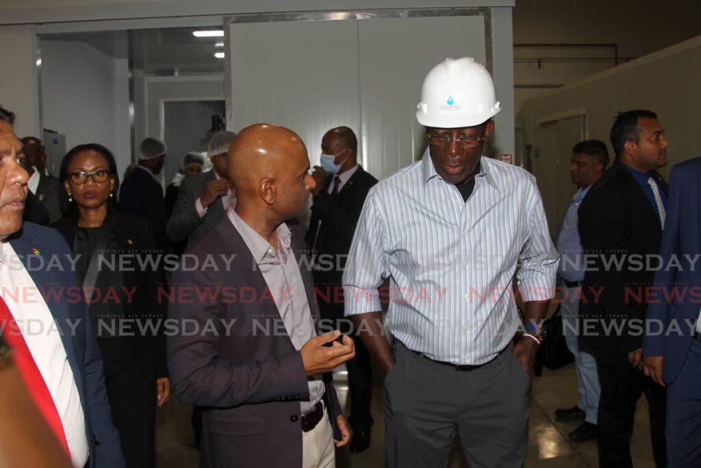 Chairman of NOVO farms Glen Ramdhanie talks with Prime Minister Dr Keith Rowley at their Point Lisas business park base ahead of a MOU signing between NOVO and the government of Guyana. Photo by Lincoln Holder