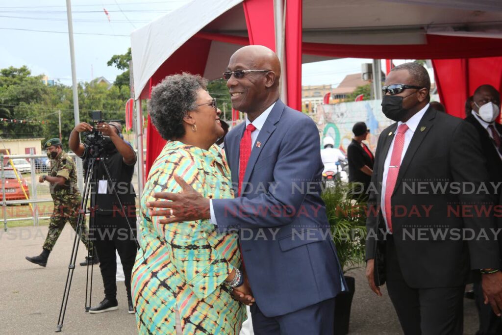 Prime Minister Dr Keith Rowley greets Barbados Prime Minister Mia Mottley on Friday at the Agri Investment Forum and Expo at the Queen's Park Savannah, Port of Spain. - SUREASH CHOLAI