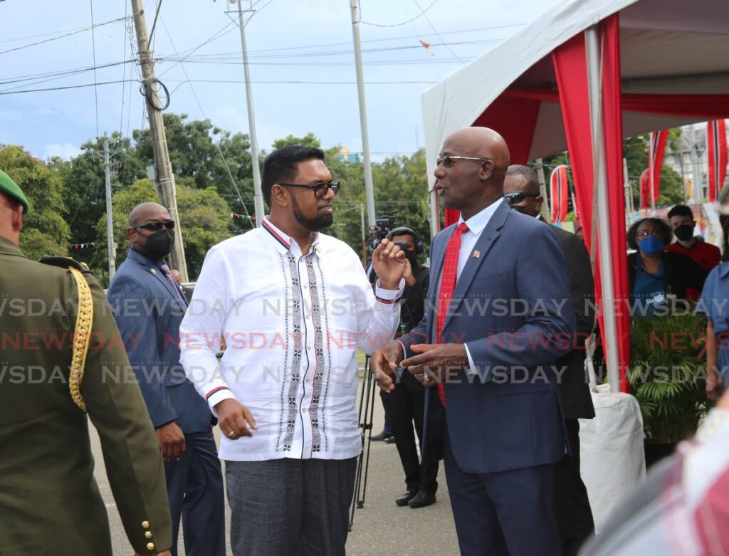 Guyana President Dr Irfaan Ali, left, and Trinidad and Tobago Prime Minister Dr Keith Rowley chat at the Agri-Investment Forum and Expo at Queen's Park Savannah, Port of Spain on Friday. - SUREASH CHOLAI