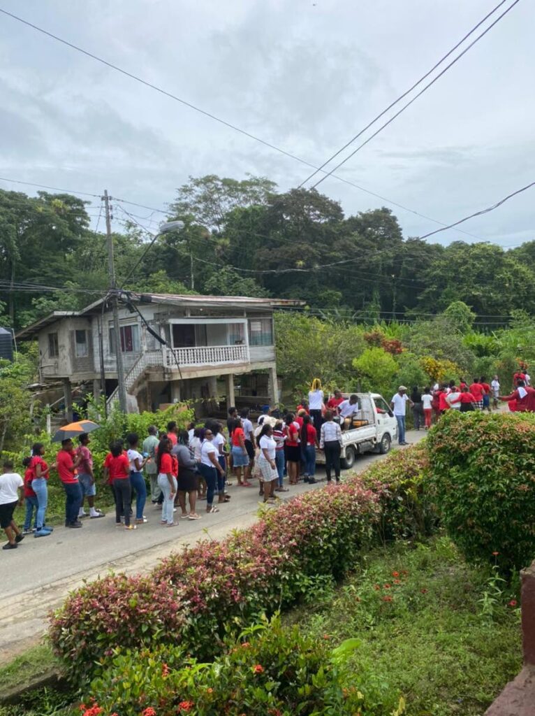 Members of the St Ann #2 Independent Baptist Missionary Union pray in front of the home of slain former lay Catholic minister Sylda Mudie on Sunday. - Courtesy St Ann #2 IBMU