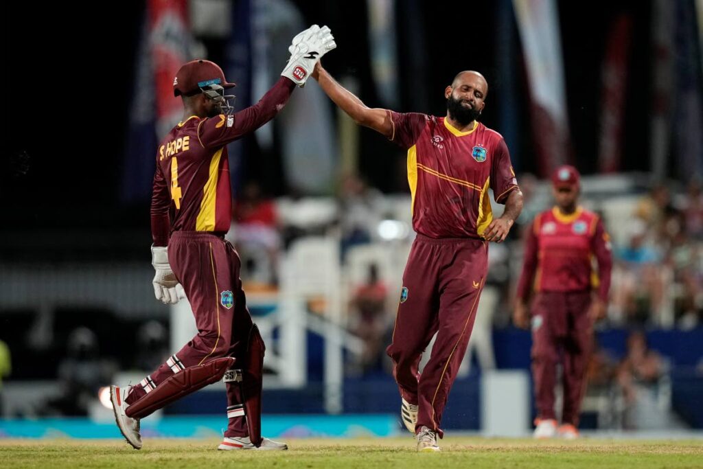 West Indies' Yannic Cariah (right) celebrates with Shai Hope the dismissal of New Zealand's Devon Conway during the third ODI at Kensington Oval in Bridgetown, Barbados, on Sunday.  (AP photo)