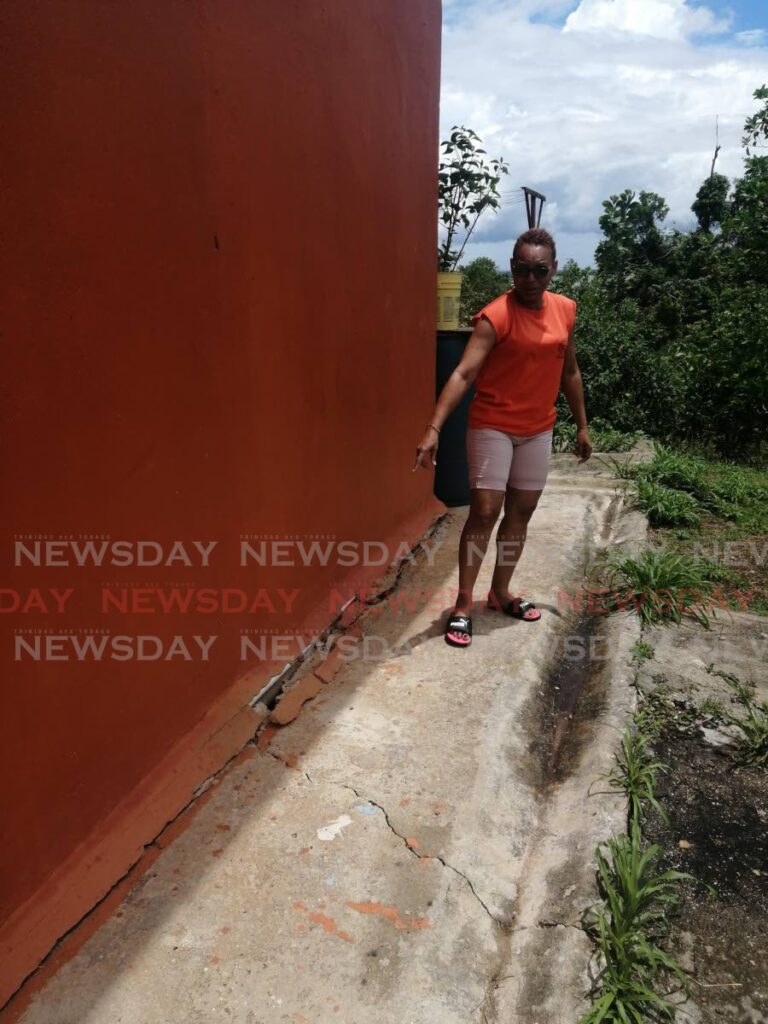 Antonia Batson shows the cracks at her Cleaver Heights, Arima home. She says the cracks are as a result of the land the house is built on, is slowly slipping away.  - Jensen La Vende