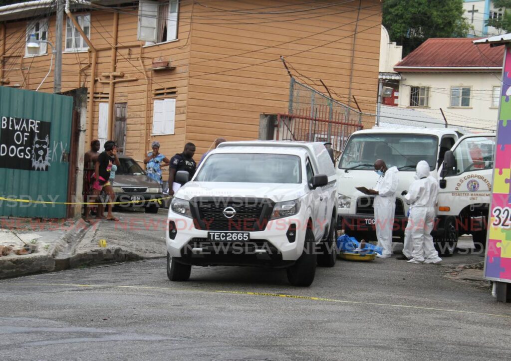 Police crime-scene investigators on the corner of Observatory and Quarry Streets, Port of Spain where Delano Pierre was shot and killed while driving a Port of Spain Corporation vehicle on Monday. - AYANNA KINSALE