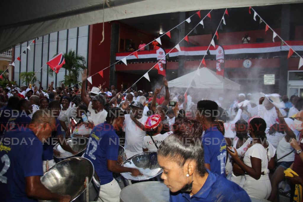 Desperadoes Steel Orchestra seranades the crowd as it is 'powdered' on Knox Street, Port of Spain, before the start of the parade. Photos by Sureash Cholai