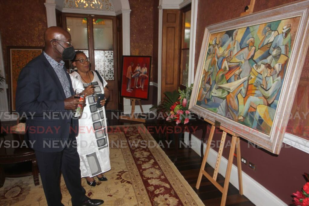 Prime Minister Dr Keith Rowley and Wendy Rocke view a painting by Sybil Atteck at the opening of an Independence Day art exibition at White Hall, Port of Spain on Wednesday. Photo by Angelo Marcelle