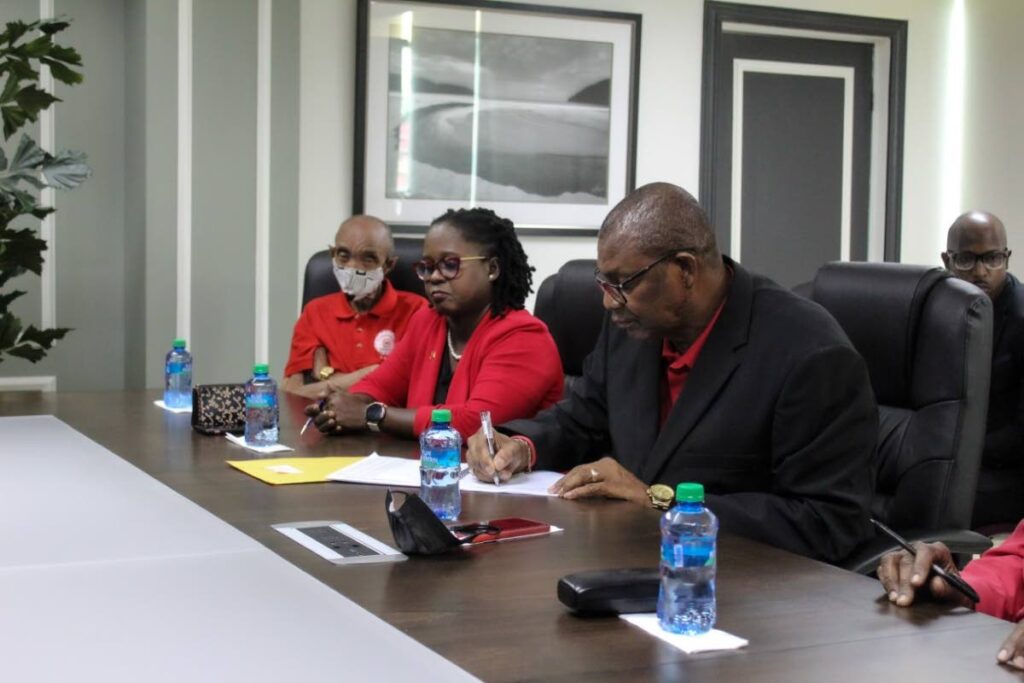 Amalgamated Workers Union president Michael Prentice signs the collective bargaining agreement at the CPO's office on Monday.  Photo courtesy Chief Personnel Officer's office
