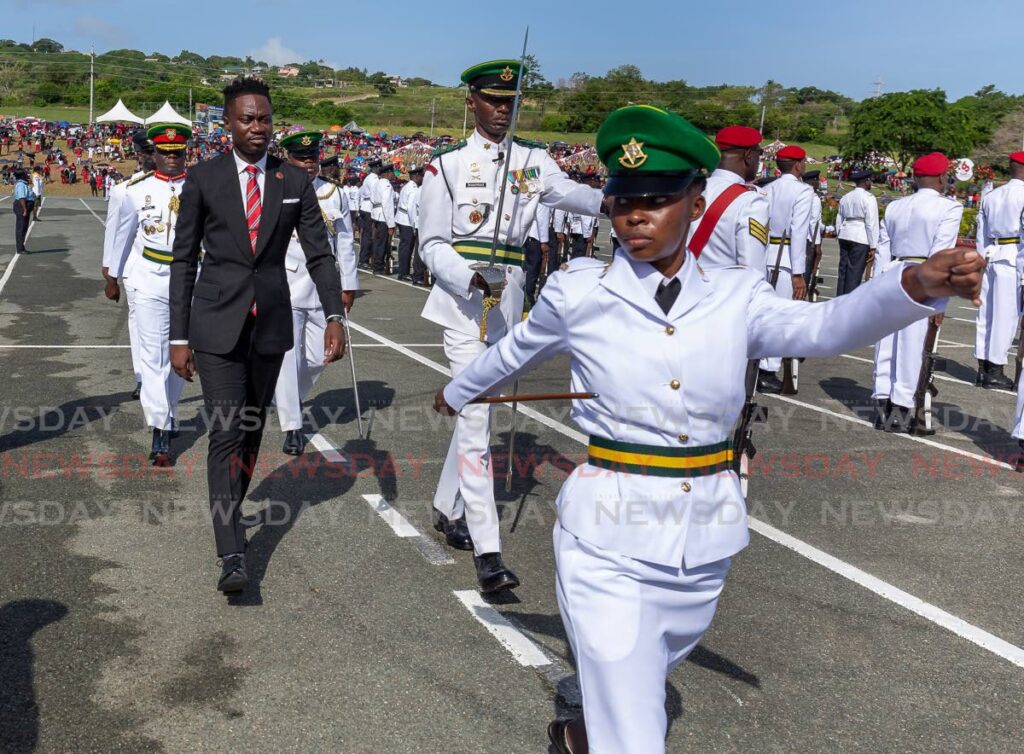 Chief Secretary Farley Augustine is led through the ranks as he inspects the various armed detachments at the Indpendence Day Parade, at Parade Grounds, Dwight Yorke stadium, Bacolet, Wednesday. - David Reid