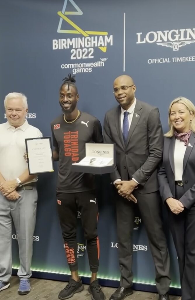 In this screengrab from a video posted to TT track and field athlete Jereem Richards' Facebook page, Richards poses with the commemorative timepiece and certificate he received for breaking the men’s 200-metre games record at the 2022 Birmingham Commonwealth Games.