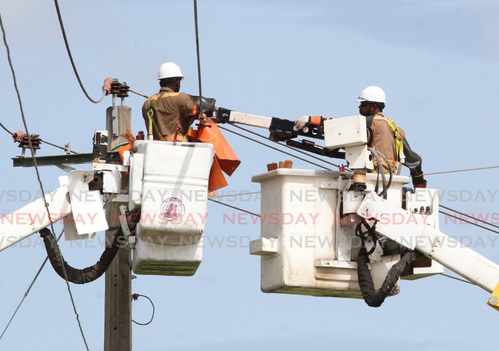 In this file photo TTEC employees work on overhead lines. The Minister of Public Utilities Marvin Gonzales said power has been restored to most communities affected by outages during bad weather over the weekend - 