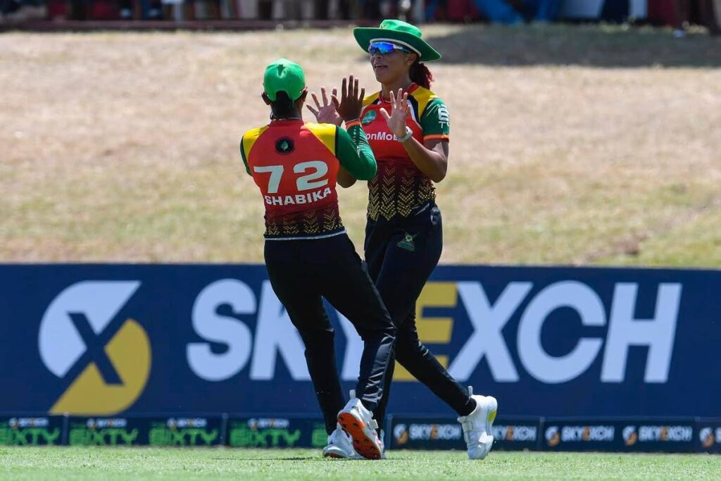 Guyana Amazon Warriors' Shabika Gajnabi (left) celebrates with teammate Cherry-Ann Fraser, the fall of a Trinbago Knight Riders wicket, during their women 6ixty tournament match, at Warner Park, Basseterre, St Kitts on August 24. PHOTO COURTESY 6IXTY CRICKET. - 