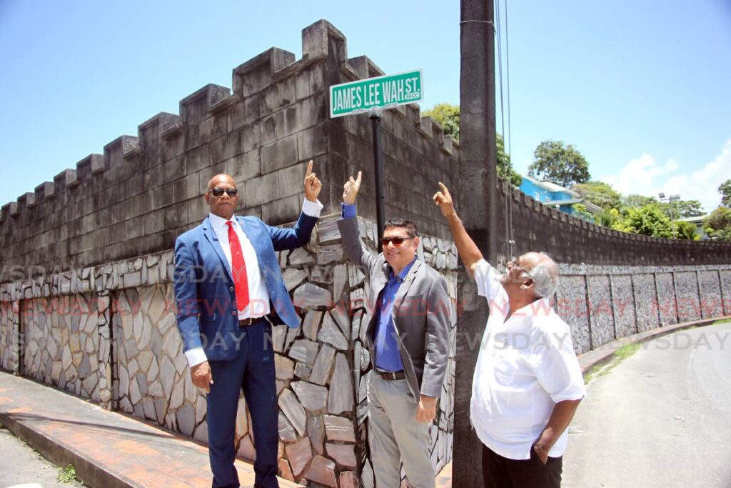 San Fernando mayor Junia Regrello, president of the Greater San Fernando Area Chamber of Commerce Kiran Singh and David Sammy, friend of the Lee Wah family, unveil the street sign at the bottom of San Fernando Hill on Thursday  - Photo by Lincoln Holder