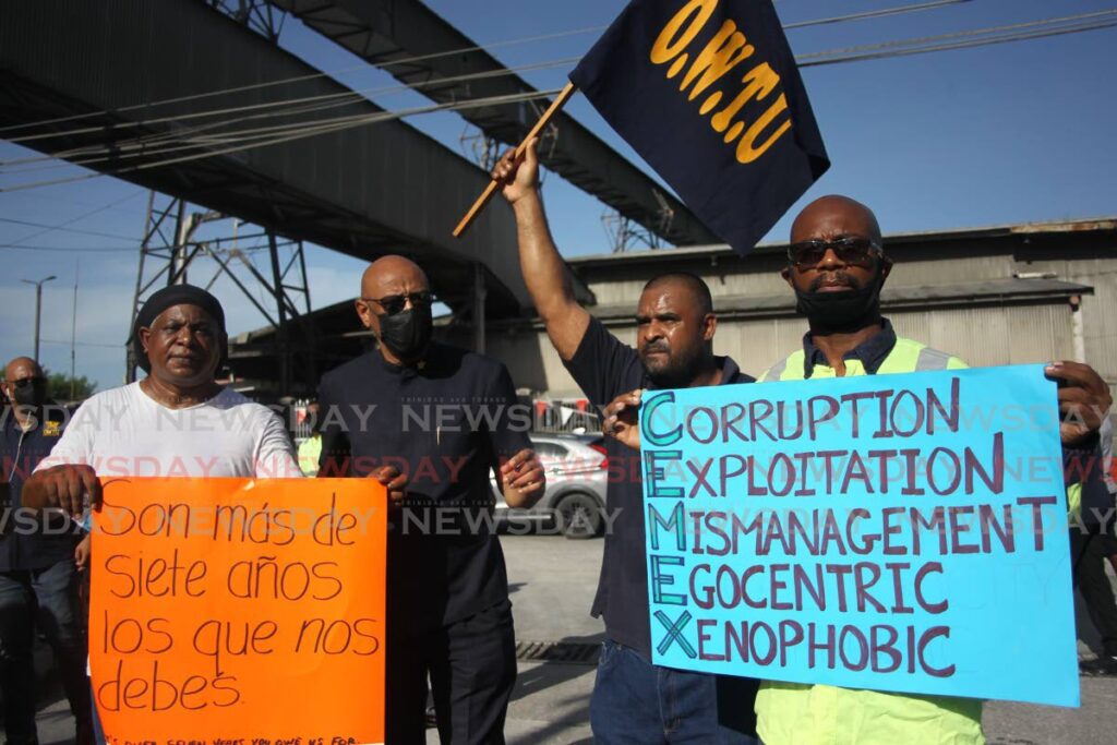 Trinidad Cement limited workers and members of the OWTU including president general Ancel Roget, staged an early morning protest outside the Claxton Bay TCL plant to highlight outstanding wage negotiations.  - Photo by Lincoln Holder