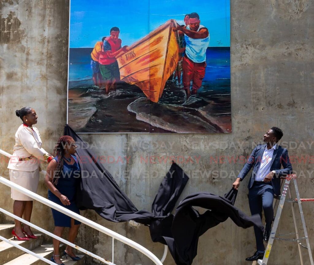 From right, Chief Secretary Farley Augustine, Dr Faith BYisrael, area representative, Belle Garden and Nathisha Charles-Pantin, secretary for Division of Food Security, National Resources, the Environment and Sustainable Development unveil the painting “Fisher Folk” by Avian Orr of Delaford at the North East Tobago UNESCO Man and the Biosphere Art Trail, Belle Garden Multipurpose Facility on Tuesday. - David Reid