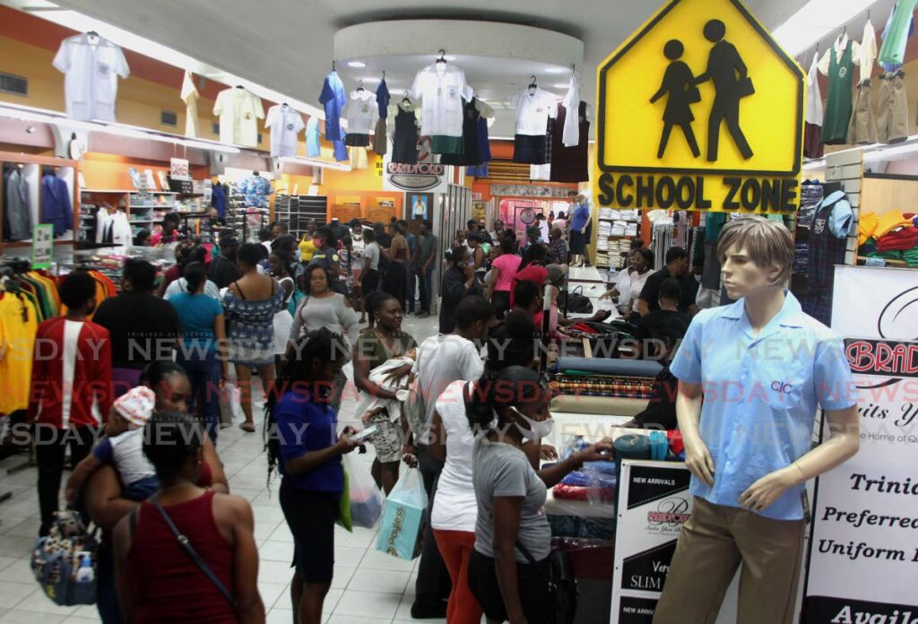 Parents and guardians shop for school supplies and uniforms for their children at Bradford Mall in Port of Spain on Saturday, ahead of the reopening of schools on Monday.  - ROGER JACOB
