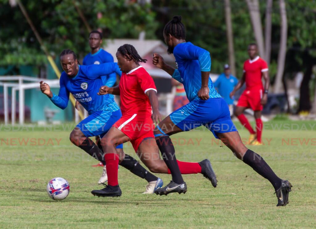Two Sidey's FC players track the run of a Charlotteville Police Youth Club player in their Tobago Ascension Premier League match at Speyside Recreation Ground on Sunday. Photo by David Reid