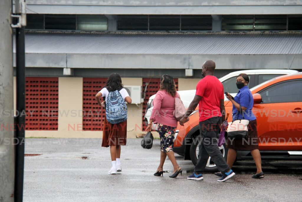 School officials walk in on the first day of the new school term at the Chaguanas South Secondary School, Helen Street, Chaguanas, on Monday. Photo by Ayanna Kinsale