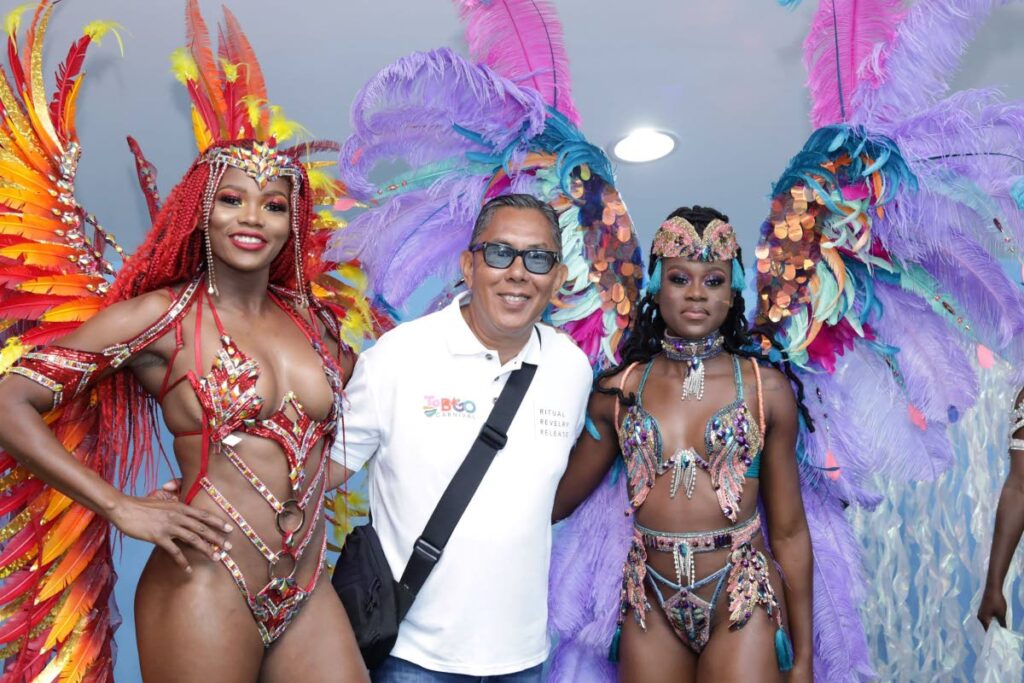 Tony Chow Lin On, centre, with two models at the media launch of the inaugural Tobago Carnival at Shaw Park Cultural Complex last month. - THA 