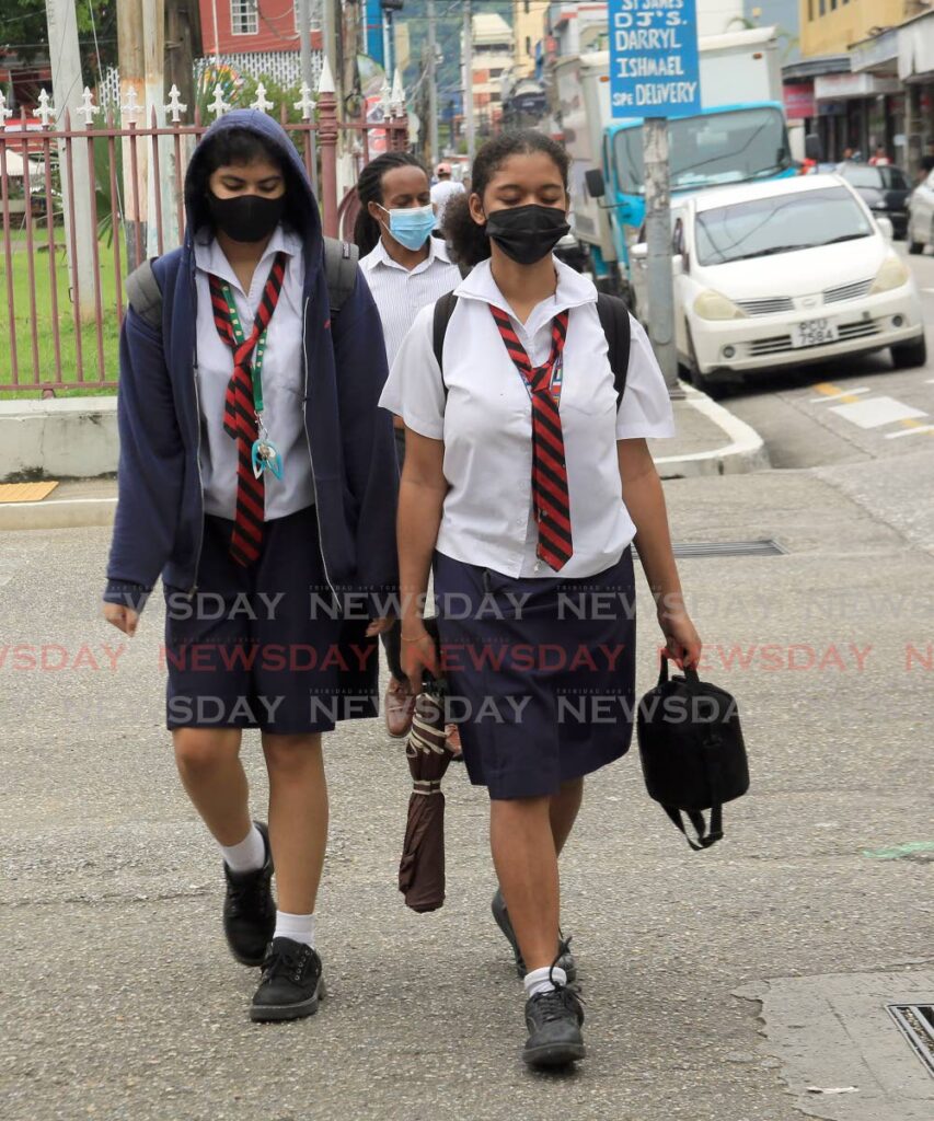 Students from Bishop Anstey High School walk through Port of Spain on their way home from school. - PHOTO BY SUREASH CHOLAI