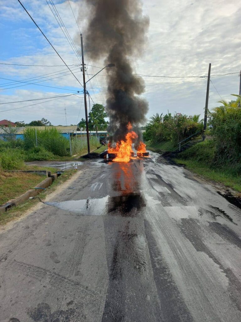 One of the roads in the Mon Desir/Rousillac area that was blocked with burning debris on Wednesday.  PHOTO COURTESY DERYCK BOWRIN - 