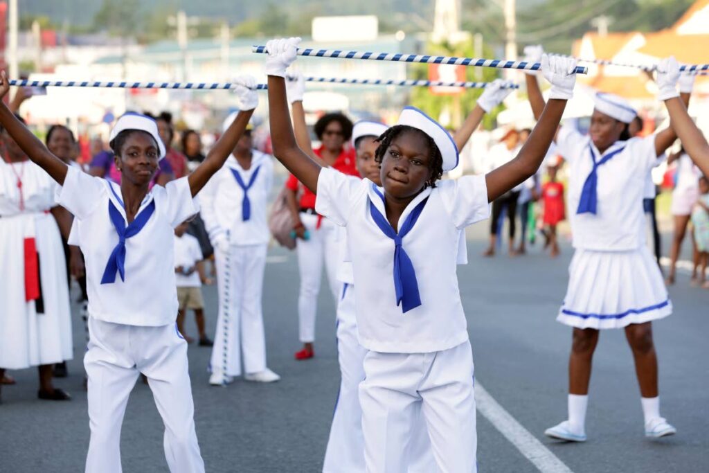 Youths play sailor mas during the street parade on Independence Day in Scarborough. - THA