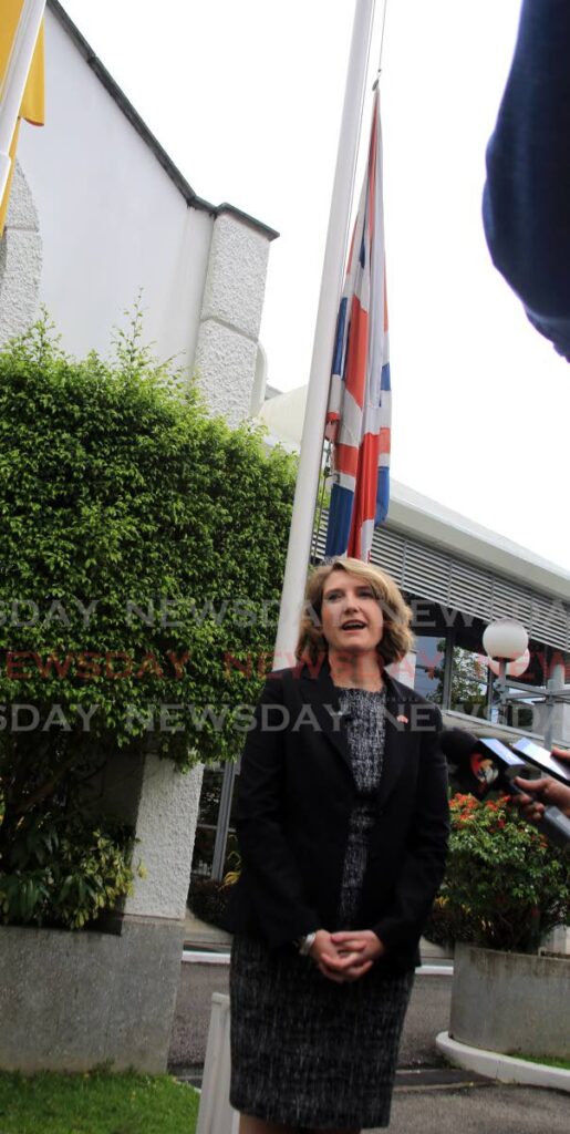 British High Commissioner Harriet Cross speaks on the death of Queen Elizabeth II outside the commission's  office on St Clair Avenue St Clair on Thursday. The British flag is being flown at half-mast behind her. Photo by Sureash Cholai