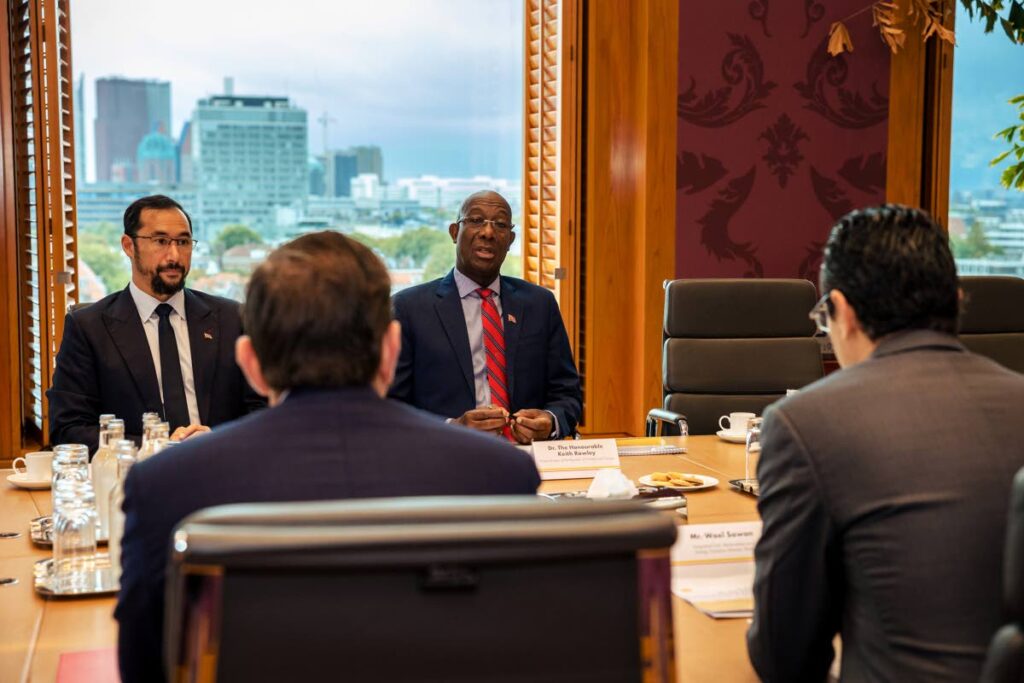 ENERGY TALKS: Prime Minister Dr Keith Rowley, background right, and Energy Minister Stuart Young. background left, speak with senior Shell executives at their offices in The Hague, Netherlands on Friday. PHOTO COURTESY OPM.
