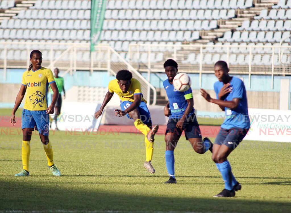 Presentation San Fernando Adah Barclay (second from left) shoots past two Naparima players during their Secondary Schools Football League (SSFL) exhibition match at the Ato Boldon Stadium, Couva on Friday. - Lincoln Holder