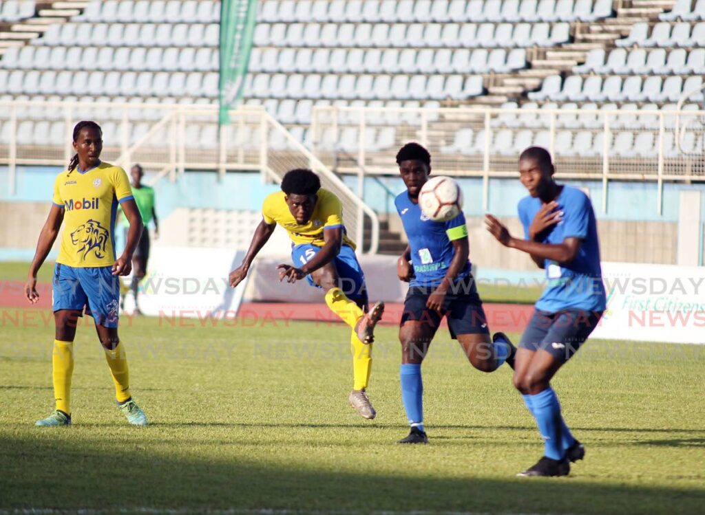 Presentation San Fernando Adah Barclay (second from left) shoots past two Naparima players during their Secondary Schools Football League (SSFL) exhibition match at the Ato Boldon Stadium, Couva on September 9. - Lincoln Holder