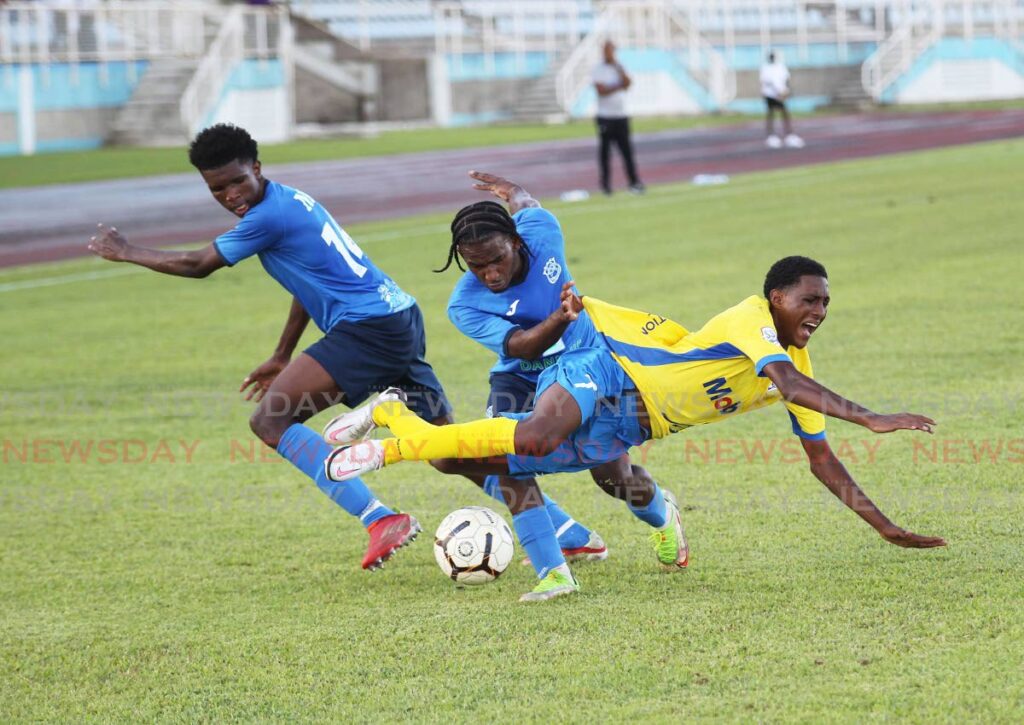 Presentation College San Fernando player Vaughn Clement, right, is fouled by a Naparima College player on Friday during the Tiger Tanks Cup at the Ato Boldon Stadium, Couva. - Lincoln Holder
