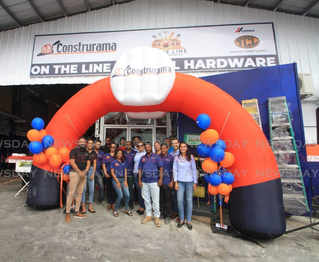 Cemex/TCL and On the Line General Hardware employees celebrate their partnership at the hardware, Endeavour Road, Chaguanas on Saturday. - ANGELO MARCELLE