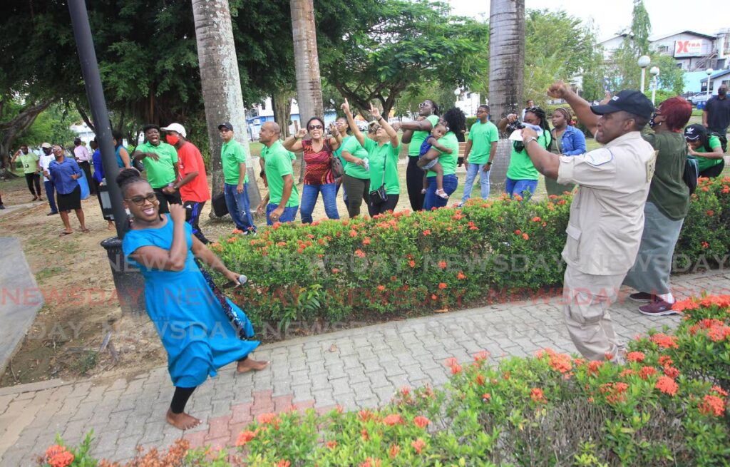 Cops in worship: Acting ACP Curt Simon and PC Nakasa Thatcher-Roberts, a worship leader of Restorative 
Centre Kingdom Community, dance during a day of prayer held by the Evangelical Council of Churches and Central Division 
police at Saith Park, Chaguanas on Saturday.
 - ANGELO MARCELLE