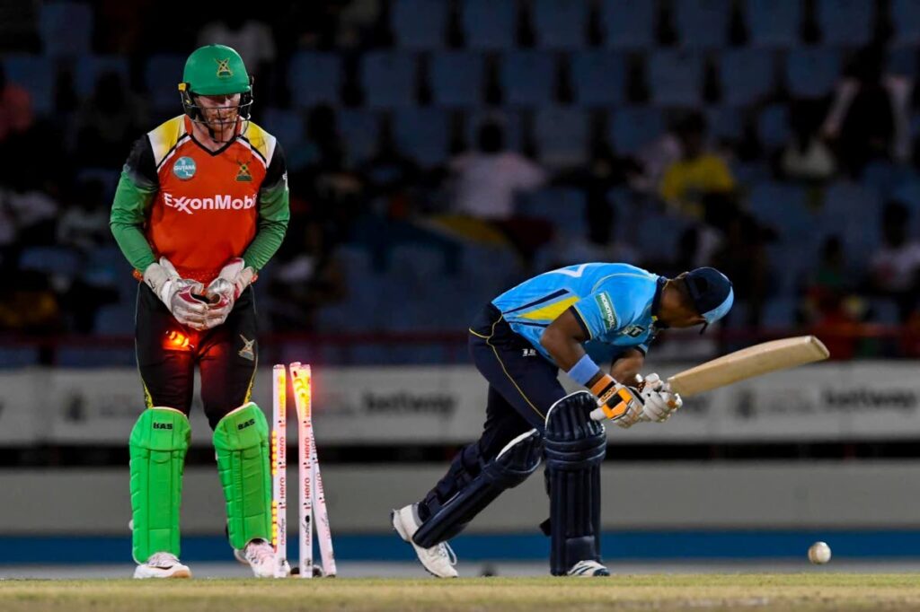 St Lucia Kings batsman Mark Deyal (right) is bowled by Guyana Amazon Warriors left-arm spinner Gudakesh Motie (not in photo), while wicketkeeper Heinrich Klaasen (left) looks on, during the teams' fixture in the Hero Caribbean Premier League (CPL), on Saturday, at the Daren Sammy Stadium, Gros Islet, St Lucia. PHOTO COURTESY CARIBBEAN PREMIER LEAGUE. - 