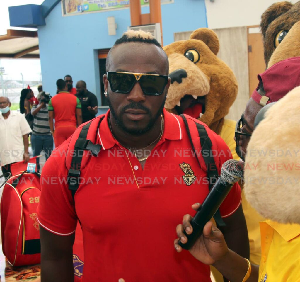 Andre Russell, upon his arrival, along with members of the Trinbago Knight Riders, at the Piarco International Airport on Monday. - SUREASH CHOLAI