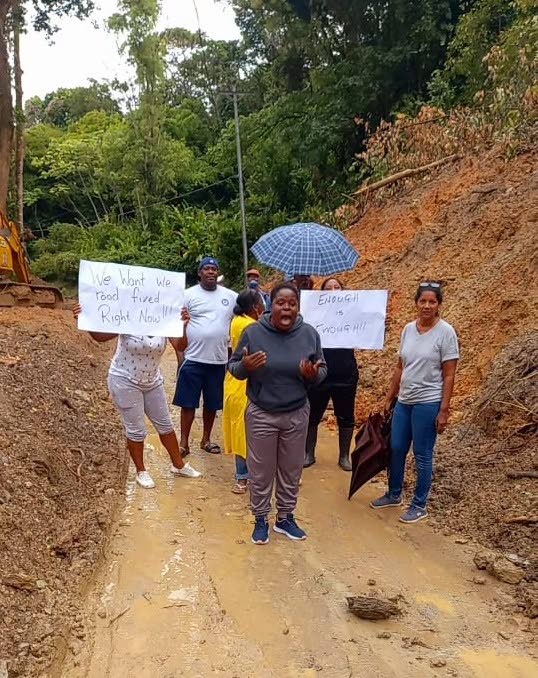 Matelot villagers protest over the condition of the Paria Main Road leading to their homes on Tuesday. - 