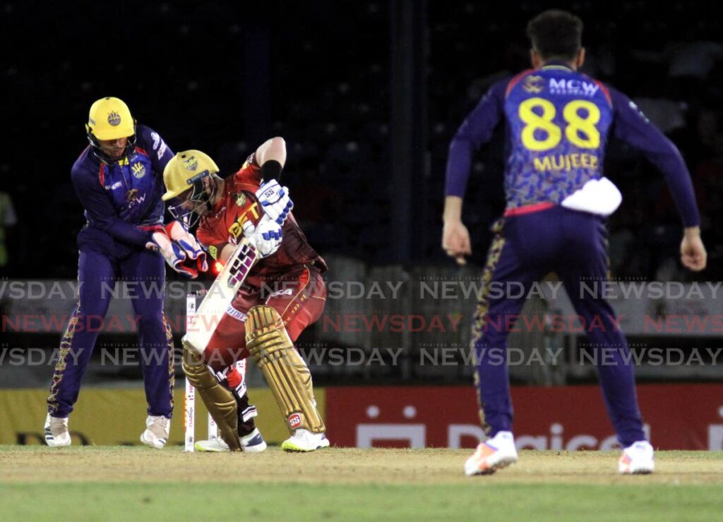 Trinbago Knight Riders batsman Tim Seifert (centre) is bowled by Barbados Royals off-spinner Mujeeb Ur Rahman (right) during the teams' Hero Caribbean Premier League match at the Queen's Park Oval, St Clair on Tuesday. Photo Ayanna Kinsale