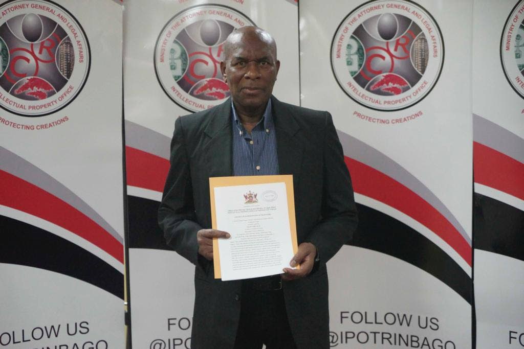 Selwyn Melville with his trademark certificate, for the Soca Warriors nickname, at the Intellectual Property Office, Port of Spain on Tuesday. PHOTO COURTESY SELWYN MELVILLE. - 