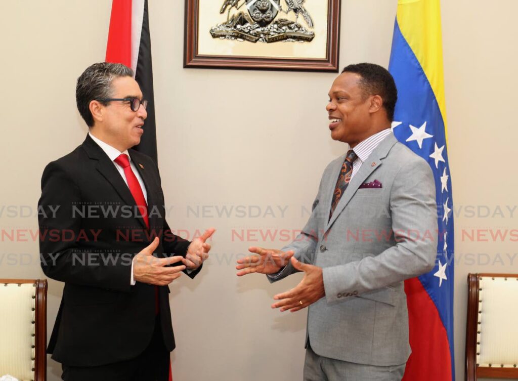 FRIENDLY TALKS: Foreign and Caricom Affairs Minister Dr Amery Browne, right, and Venezuela's ambassador Alvaro Cordero speak on Wednesday at Browne's office in St Clair. PHOTO BY ROGER JACOB - 