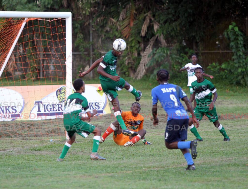 St Augustine Secondary School defender Tyrese Andrews (second from left) prevents the ball during from going into the back of the net during his team’s match against Naparima College in their Secondary Schools Football League (SSFL) Premier Division, at the St Augustine Secondary School Ground in St Augustine, on Wednesday. Photo by Ayanna Kinsale