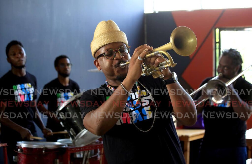 Entienne Charles plays his trumpet with his rhythm section at the launch of his carnival band Riddim Brass and Mas at Sound Forge on Christopher Samuel Drive, St James on Friday. - Sureash Cholai