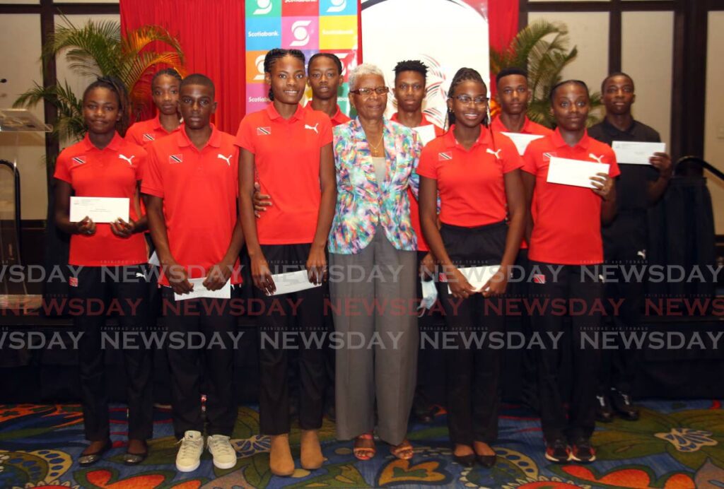 Crispina Edmund (middle), mother of late Trinidad and Tobago Olympian Deon Lendore, with the ten junior athletes who benefitted from the Deon Lendore Bursary at a ceremony at the Hilton Hotel, St Clair on Saturday. - SUREASH CHOLAI